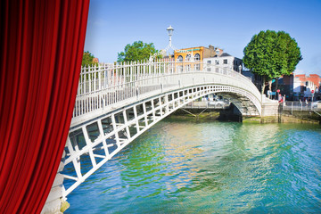 Open theater red curtains against the most famous bridge in Dublin called "Half penny bridge" (Ireland) - concept image