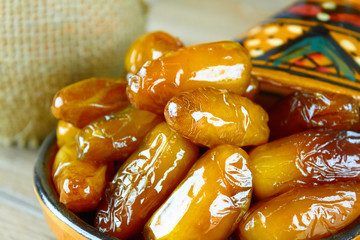 sweet algerian dates fruits on arabic traditional pottery plate