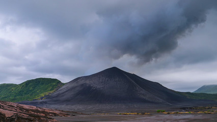 Mist and ash is coming out of a crater at the summit of Mount Yasur in Vanuatu.