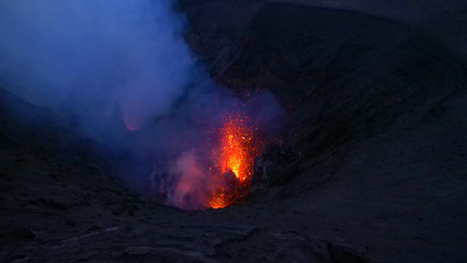 CLOSE UP: Breathtaking shot of magma and smoke rising out of an active crater.