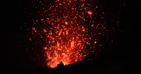 Fototapeta na wymiar CLOSE UP: Dangerous chunks of searing hot magma comes flying out of volcano.