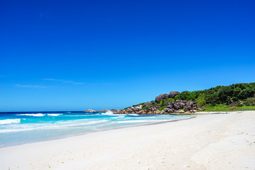 Fototapeta na wymiar White sand, palm trees, granite rocks and turquoise water at the paradise beach at grand anse, la digue, seychelles 3