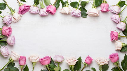 Flowers valentine day composition. Frame made of pink rose on gray background. Flat lay, top view, copy space.