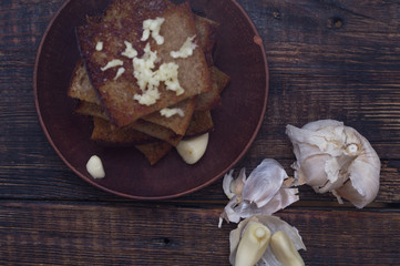 Fried bread with garlic. Peeled garlic and croutons.