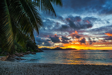 Beautiful romantic afterglow on paradise beach at anse severe, la digue, seychelles