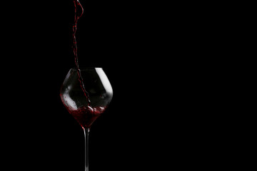 red wine pouring in glass baner. bartender on waiter concept on black background