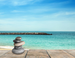 Picturesque view of ocean with rock breakwater on sunny day