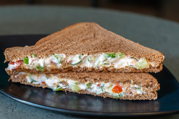 Vegan sandwich with whole grain bread, tomato, cucumber and cheese, healthy food concept, close up