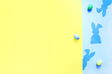 Paper Easter Bunny on yellow and blue background.