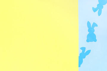 Paper Easter Bunny on yellow and blue background.