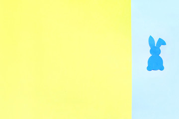 Paper Easter Bunny on yellow and blue background.