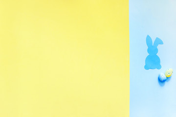 Paper Easter Bunny on yellow and blue background.