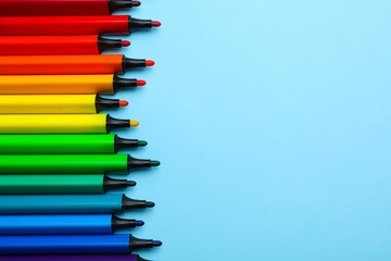 Flat lay composition with markers and space for text on color background. Rainbow palette