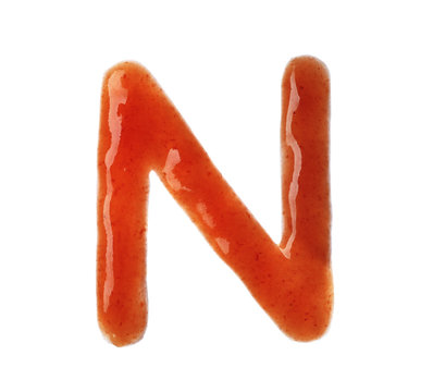 Letter N written with red sauce on white background