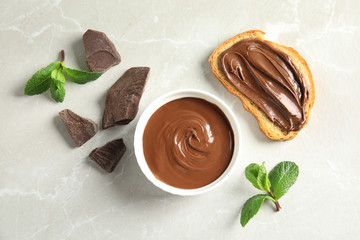 Flat lay composition with tasty chocolate mousse, bread and mint on table