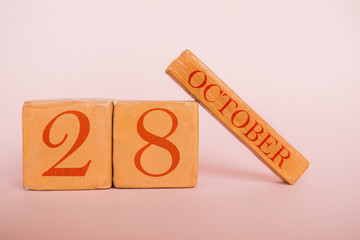 october 28th. Day 28 of month, handmade wood calendar  on modern color background. autumn month, day of the year concept