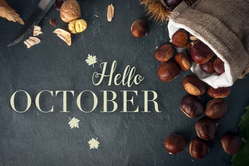 Fotobehang Hello october card. Roasted chestnuts on a rock table. © cristianstorto