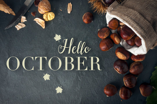 Hello october card. Roasted chestnuts on a rock table.