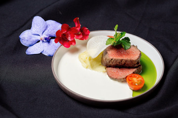 Beef tenderloin with cream sauce and green butter.