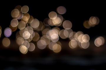 Abstract light blurred bokeh on dark background.