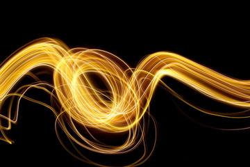 Gold light painting photography, long exposure photo of fairy lights in swirls and ripples,...