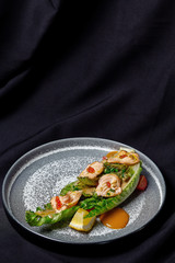 Roasted salmon on Romano with nut sauce and red caviar.