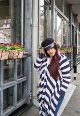 Young lady with long beautiful hair with black hat walking