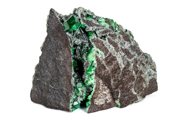 Macro stone garnet mineral, Uvarovite in rock on a white background