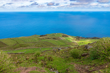 Fototapeta premium Hill of farm fields in the Corvo island in Azores, Portugal.