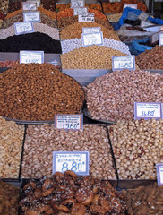 piles of colorful nuts and spices at a food market