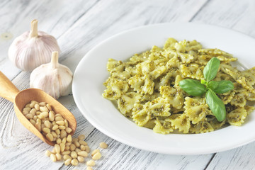 Portion of farfalle with pesto with ingredients