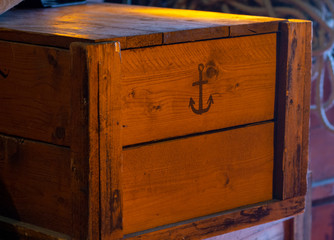 wooden box with an anchor on the deck of a ship