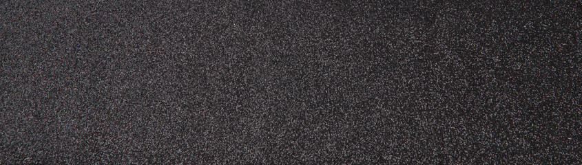 Silver sequins pattern. Sparkling sequins on black wool fabric as background
