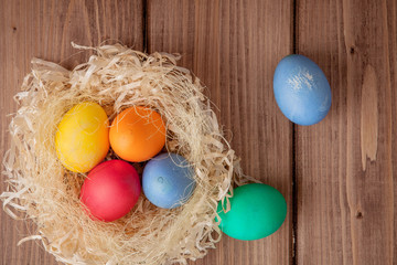 Colorful Easter eggs on wooden background with copy space
