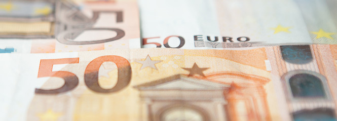 Closeup of a group of fifty euros banknote background
