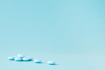 Blue pills on blue background with copy space