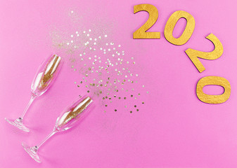 Champagne glasses with splash of golden confetti. Top view. Cele