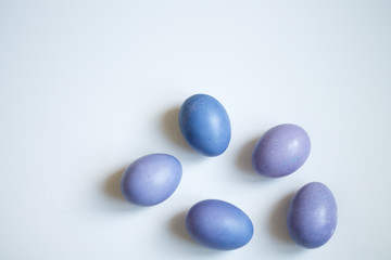 painted eggs on a light purple background Easter