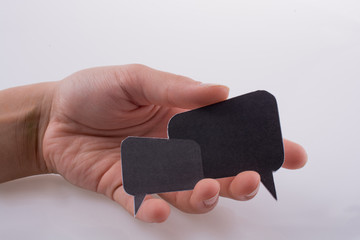 Hand holding dialogue boxes