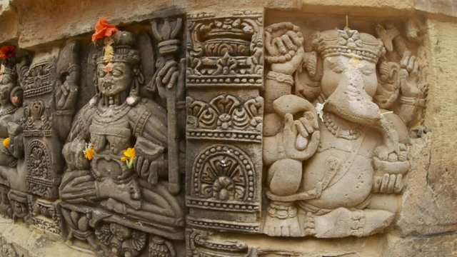 old bas-reliefs angry goddess and Ganesh hindu god with elephant head ancient temple of Parashurama