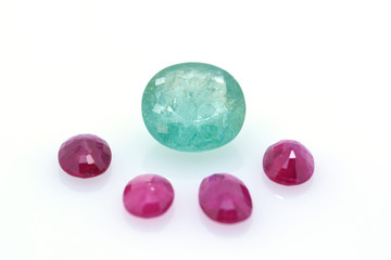 Great blue polished precious paraiba surrounded by red precious stones. Jewelry and gemology.