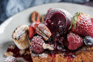 Gourmet brioche french toast with berries and marshmallows. Horizontal. Closeup. Selective focus.