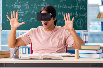 Young male student in the classroom 