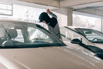 Thief robbing a car