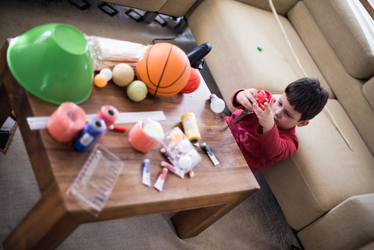 Home alone child playing with scisors