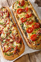 Delicious casserole sandwich with bacon, mushrooms, tomatoes and mozzarella cheese close-up. vertical