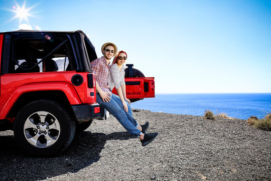 Red summer car and two people 