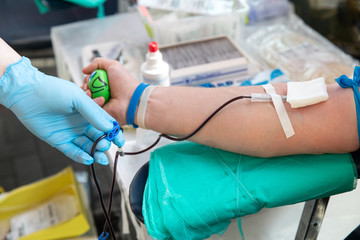 Blood donor at donation. Nurse receiving blood from blood donor