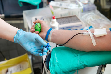 Blood donor at donation. Nurse receiving blood from blood donor