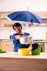 Young man in water leakage from the neighbors concept 